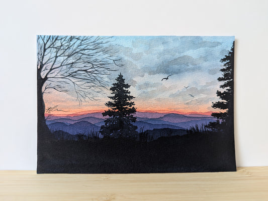 Scenic painting of a sunset over mountains with trees and birds.