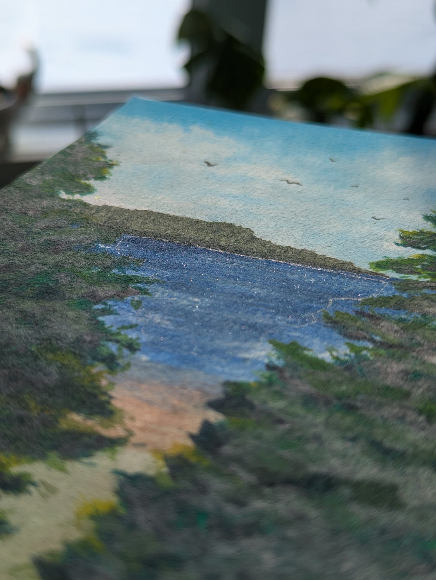 Close-up of a painted landscape with  shimmering water and trees